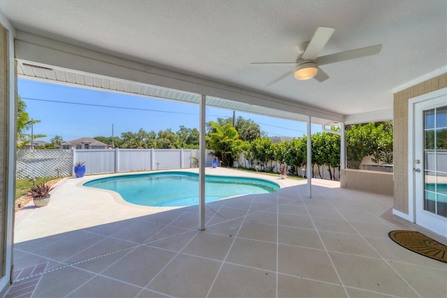 view of pool with a patio and ceiling fan