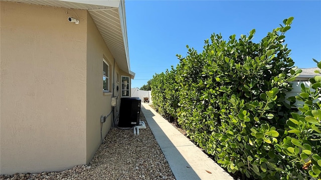 view of side of property with central air condition unit