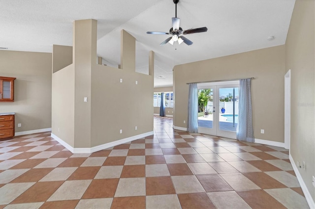 unfurnished living room featuring light tile floors, ceiling fan, and french doors