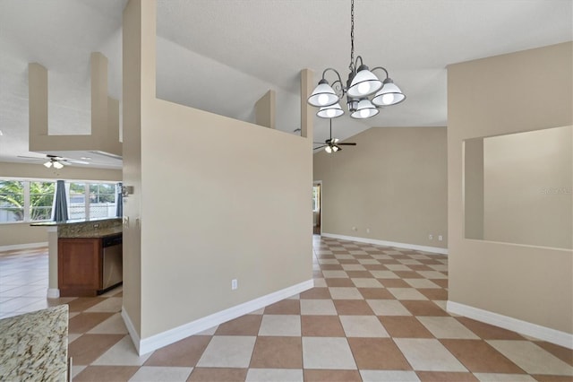 empty room with high vaulted ceiling, ceiling fan with notable chandelier, and light tile floors