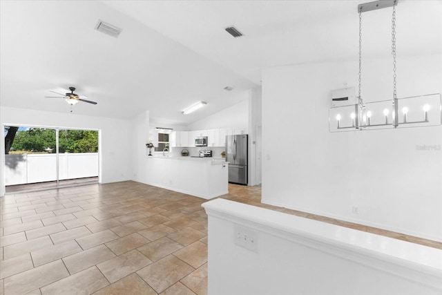 unfurnished living room featuring lofted ceiling, ceiling fan with notable chandelier, and light tile patterned floors