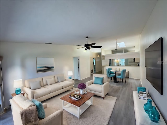 living room featuring wood-type flooring and ceiling fan