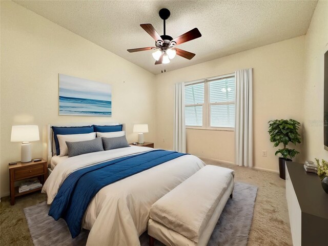 bedroom featuring a textured ceiling, carpet flooring, and ceiling fan