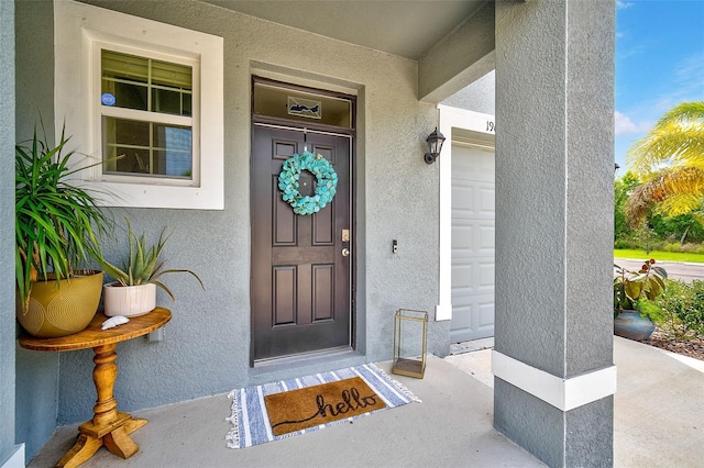 view of exterior entry featuring a garage