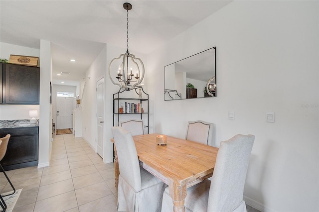 tiled dining room featuring a notable chandelier