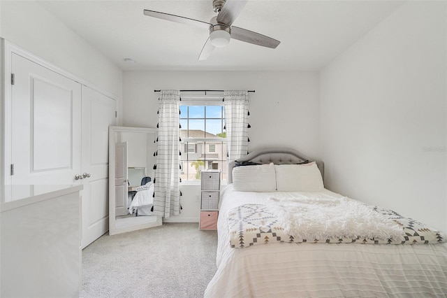 bedroom with ceiling fan, a closet, and light colored carpet