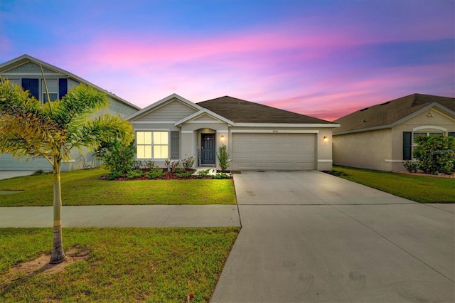 view of front of property featuring a yard and a garage