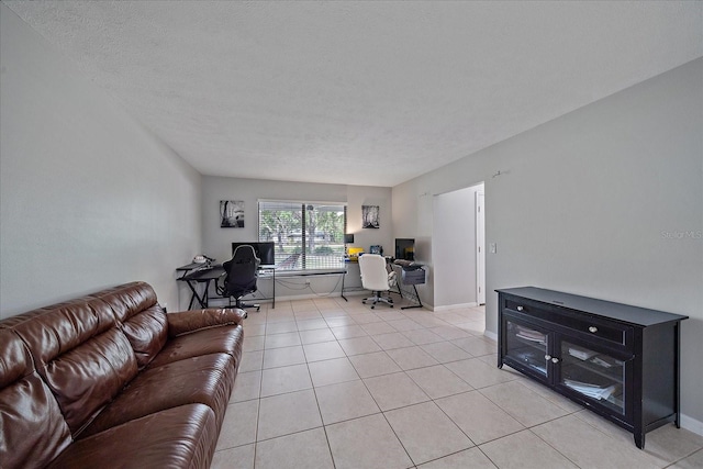 living room featuring a textured ceiling and light tile floors