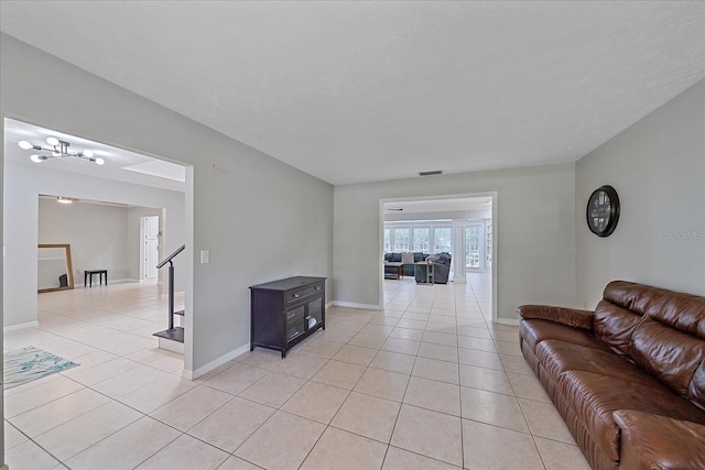 living room featuring a chandelier and light tile floors