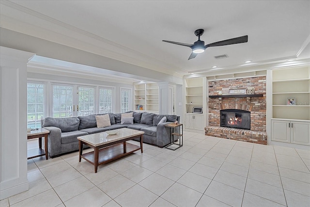 living room with ceiling fan, ornamental molding, a fireplace, and built in shelves