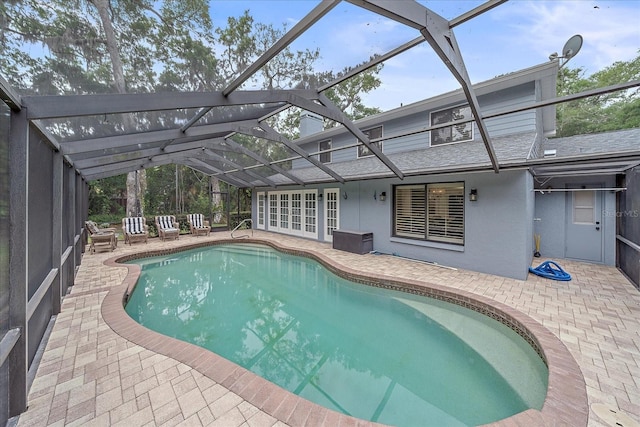 view of swimming pool with a lanai and a patio