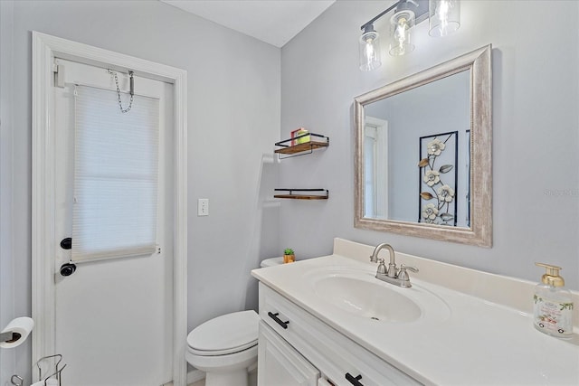 bathroom with toilet and large vanity