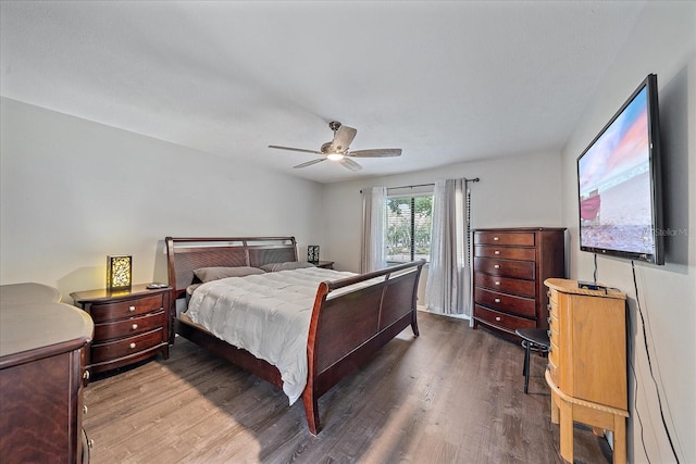 bedroom with ceiling fan and dark wood-type flooring