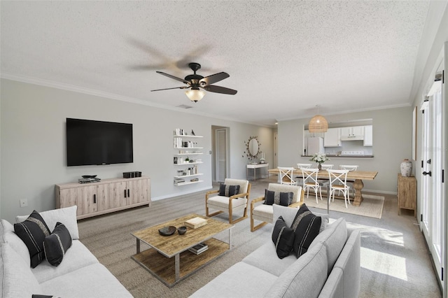 carpeted living room featuring a textured ceiling, crown molding, and ceiling fan