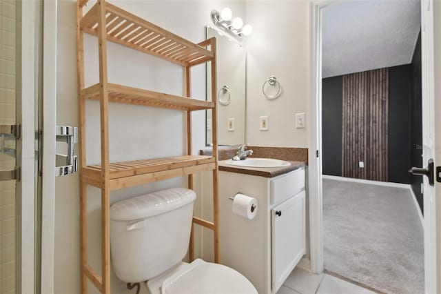 bathroom featuring tile floors, toilet, and vanity with extensive cabinet space