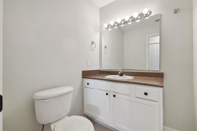 bathroom featuring vanity and toilet