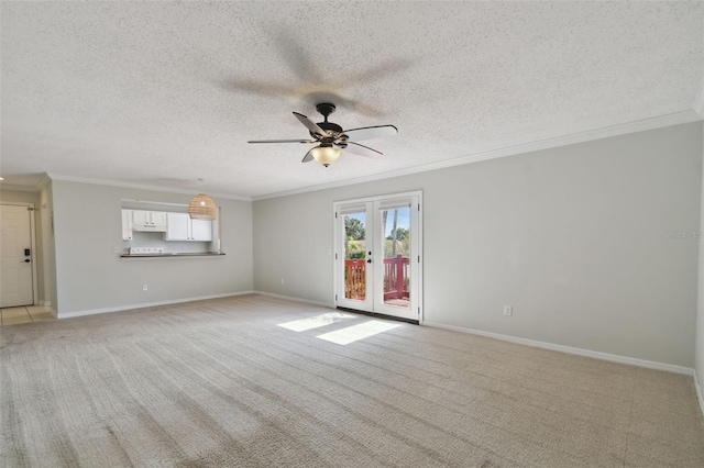 carpeted spare room featuring ceiling fan, a textured ceiling, and ornamental molding