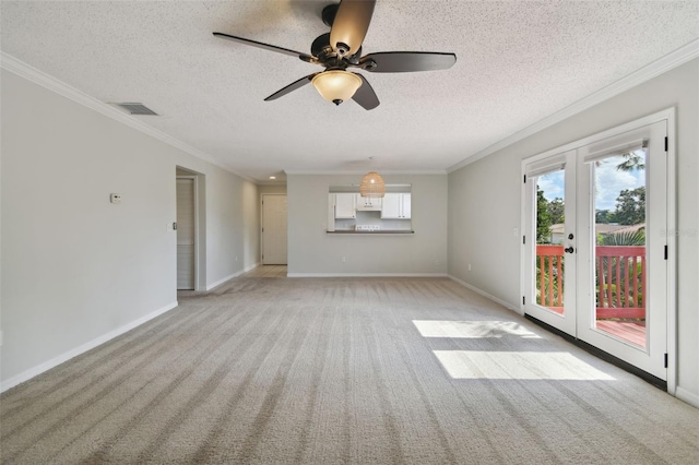 unfurnished room featuring light colored carpet, ornamental molding, and a textured ceiling