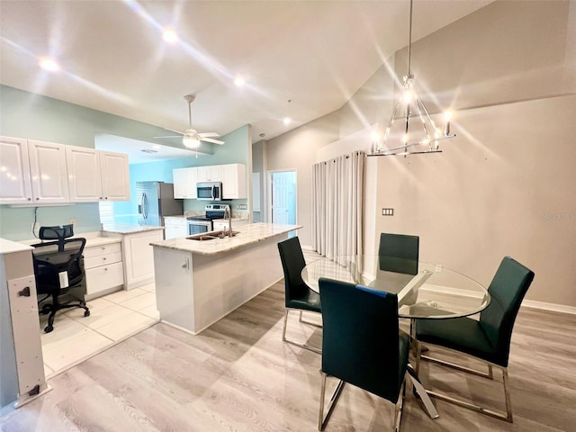 tiled dining area with ceiling fan with notable chandelier