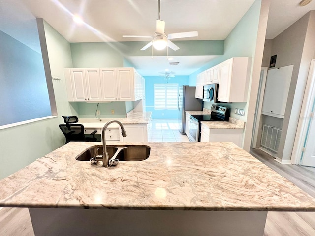 kitchen with ceiling fan, sink, light hardwood / wood-style floors, white cabinetry, and stainless steel appliances