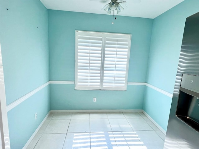 empty room featuring ceiling fan and light tile floors