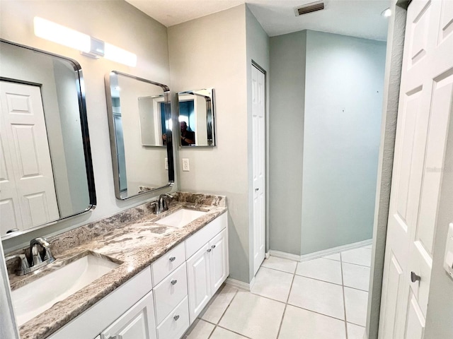 bathroom with tile flooring and double vanity