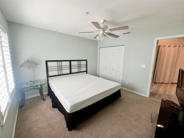 bedroom featuring a closet, ceiling fan, and carpet floors