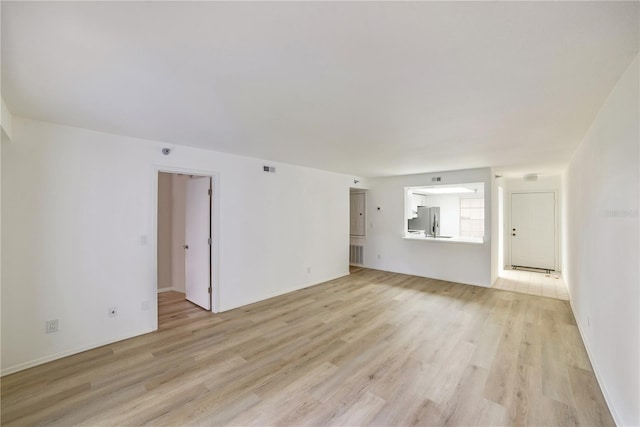 unfurnished living room featuring light wood-type flooring