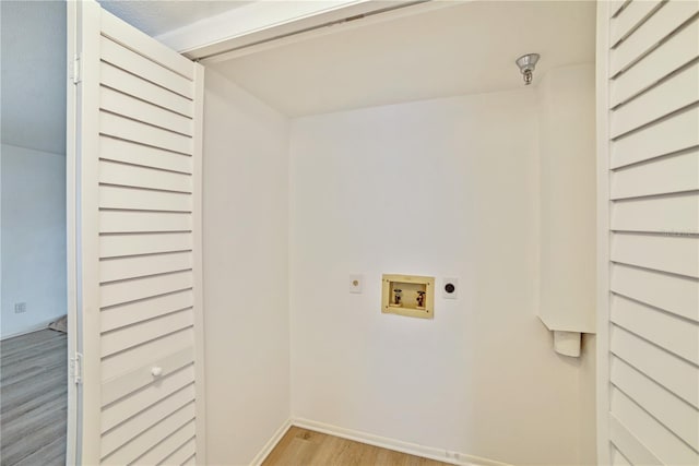 clothes washing area featuring electric dryer hookup, light wood-type flooring, and hookup for a washing machine