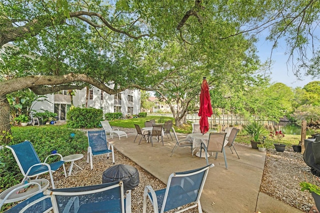 view of patio featuring fence and outdoor dining space