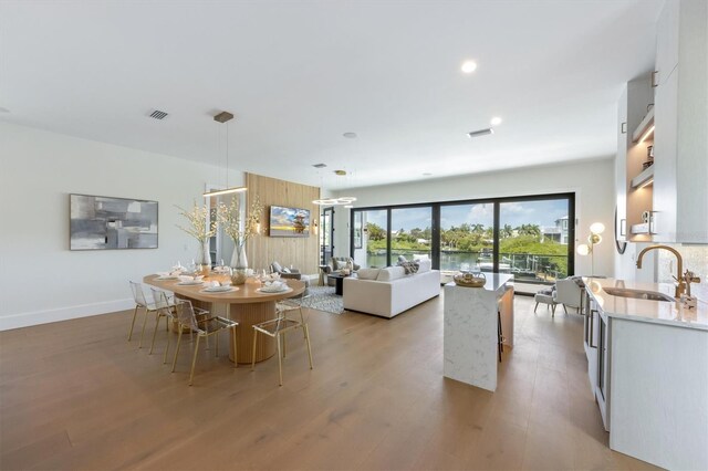 dining space featuring light hardwood / wood-style flooring and sink