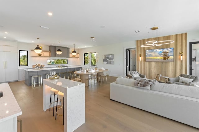 living room featuring an inviting chandelier and light hardwood / wood-style floors