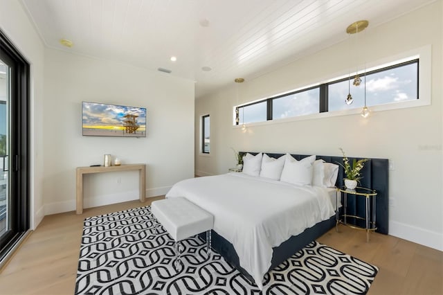 bedroom with wooden ceiling, hardwood / wood-style flooring, and access to exterior