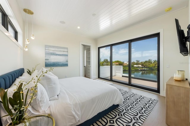 bedroom featuring wood-type flooring, access to exterior, and wooden ceiling