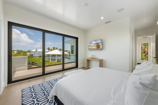 bedroom with access to exterior and light wood-type flooring