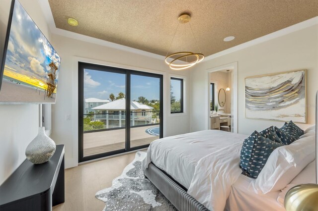 bedroom with light wood-type flooring, connected bathroom, access to outside, and a textured ceiling