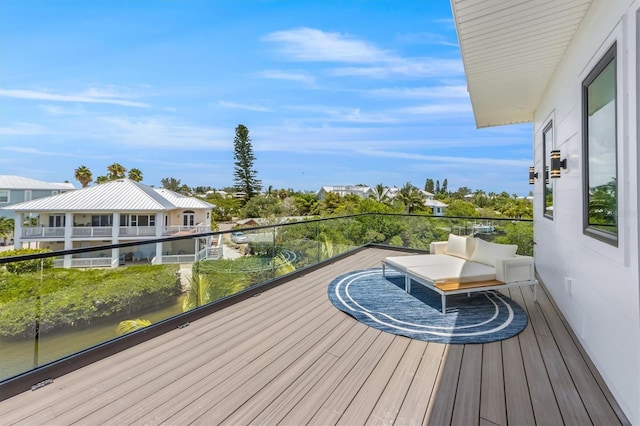 wooden terrace featuring a water view