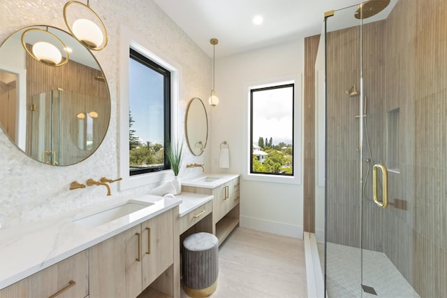 bathroom featuring vanity, hardwood / wood-style flooring, walk in shower, and backsplash