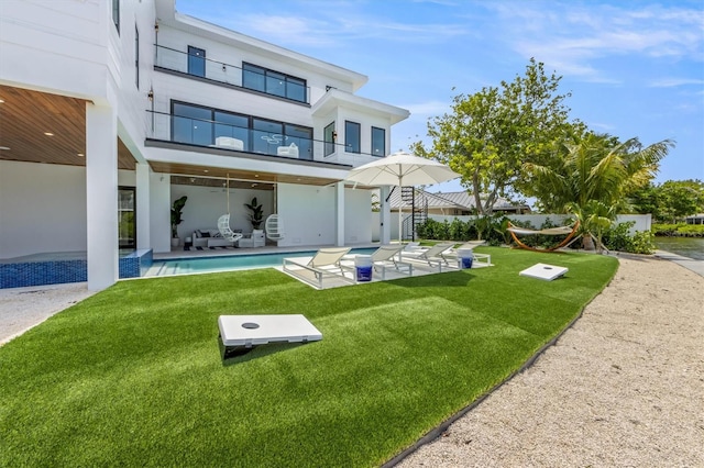 rear view of property featuring a patio area and a yard