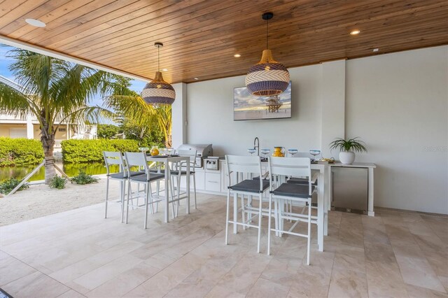 view of patio featuring exterior kitchen, ceiling fan, and grilling area