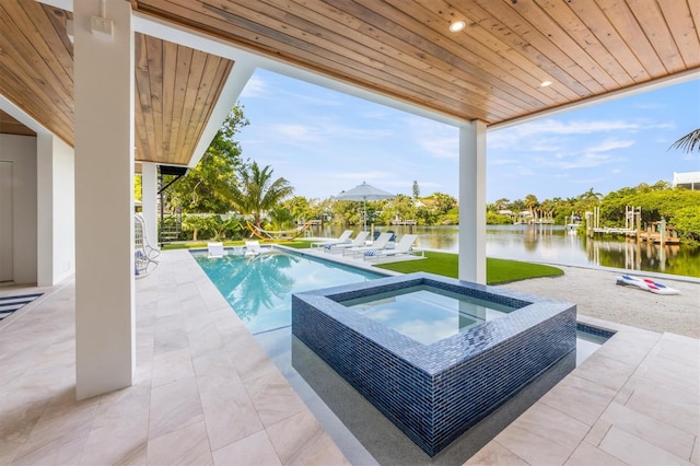 view of swimming pool with a water view, a patio area, and an in ground hot tub