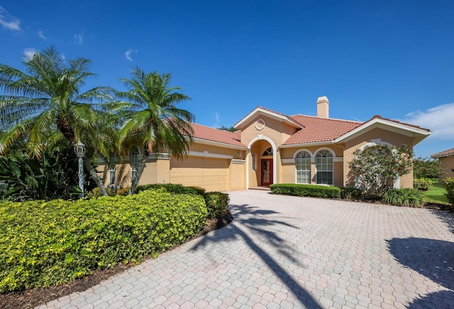 mediterranean / spanish home featuring a garage