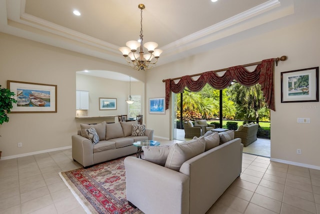 tiled living room with a raised ceiling and a notable chandelier