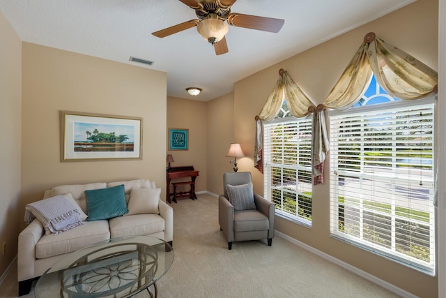 carpeted living room featuring ceiling fan