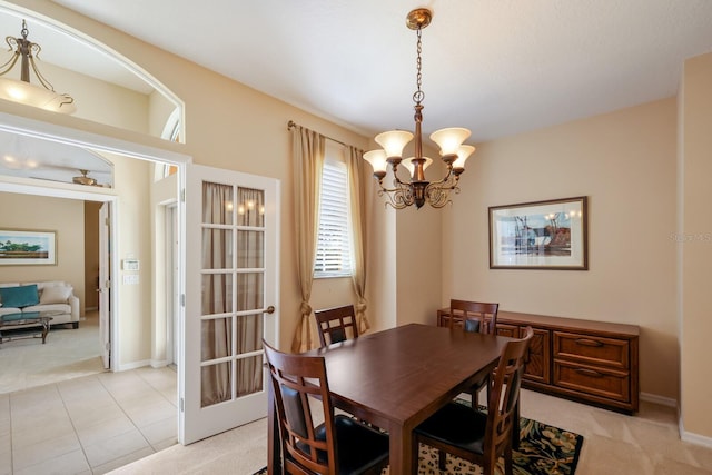 tiled dining space featuring a chandelier