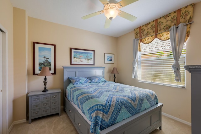 bedroom with light carpet and ceiling fan