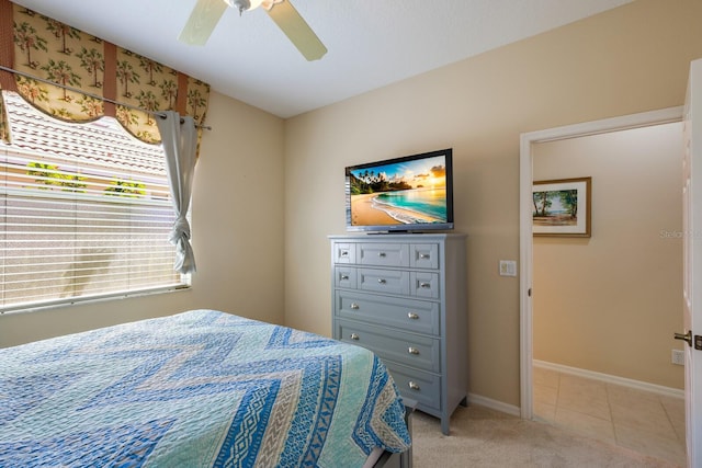 bedroom featuring light carpet and ceiling fan