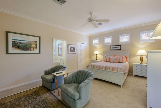 carpeted bedroom featuring crown molding, ensuite bath, and ceiling fan