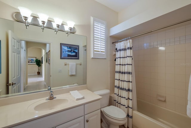 full bathroom featuring toilet, vanity, and shower / tub combo with curtain