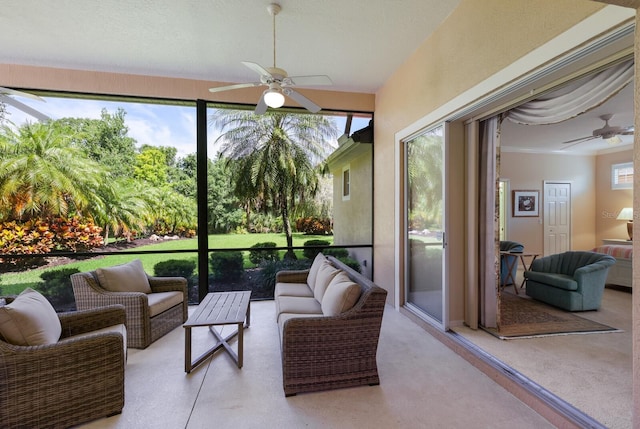 sunroom / solarium featuring a healthy amount of sunlight and ceiling fan